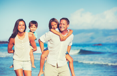 Young Happy Family Having Fun on the Beach Outdoors